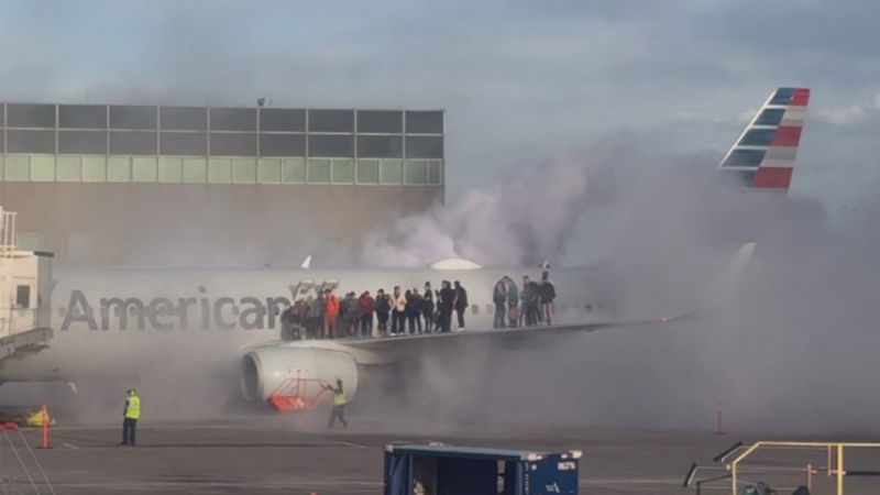 plane catches fire at us airport video shows passengers on wing